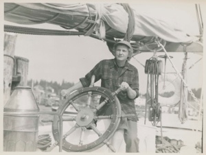 Image of Miriam MacMillan at wheel aboard the Schooner Bowdoin